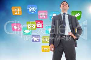 Composite image of cheerful businessman with hand on hip