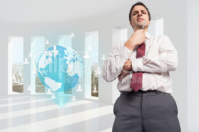 Composite image of thoughtful businessman holding pen to chin