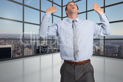 Composite image of businessman standing with arms pushing up