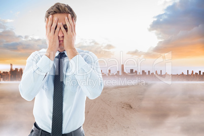 Composite image of businessman with a headache