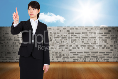 Composite image of focused businesswoman pointing