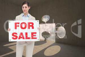 Composite image of estate agent holding for sale sign
