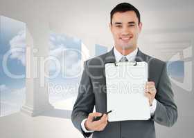 Composite image of businessman pointing with pen on clipboard