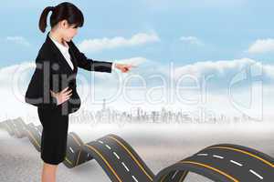 Composite image of focused businesswoman pointing