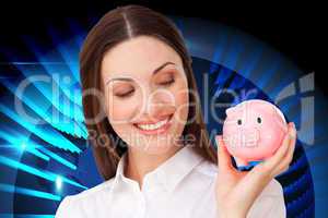 Composite image of confident businesswoman holding a piggybank