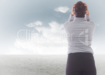 Composite image of businesswoman with hands on head