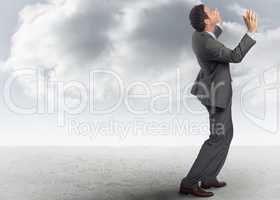 Composite image of businessman posing with arms raised