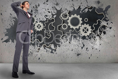 Composite image of thinking businessman scratching head