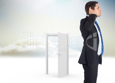 Composite image of thinking businessman scratching head