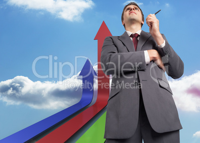 Composite image of thoughtful businessman holding pen