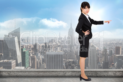 Composite image of businesswoman pointing