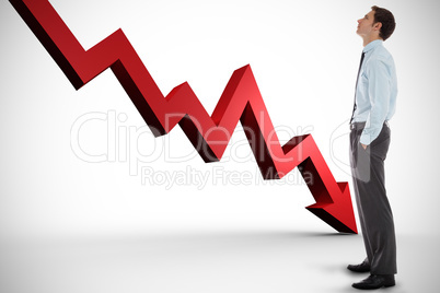 Composite image of serious businessman standing with hands in po