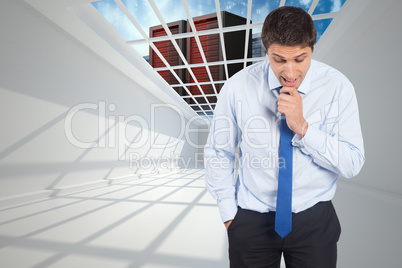 Composite image of thinking businessman touching his chin