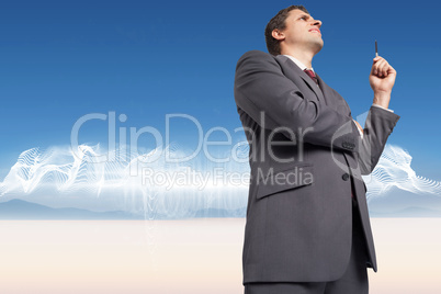 Composite image of thoughtful businessman holding pen