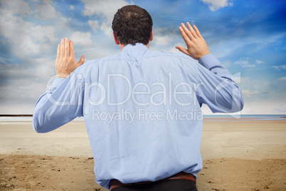 Composite image of businessman posing with arms raised