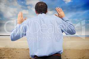 Composite image of businessman posing with arms raised