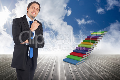 Composite image of thinking businessman holding pen