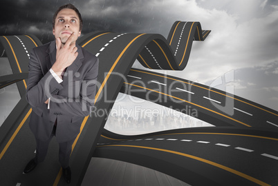 Composite image of thinking businessman touching his chin