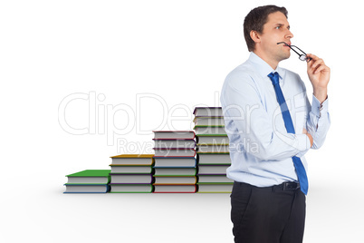 Composite image of thinking businessman biting glasses