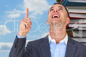 Composite image of cheerful businessman pointing upward