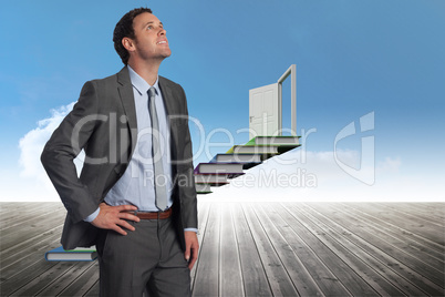 Composite image of smiling businessman with hand on hip