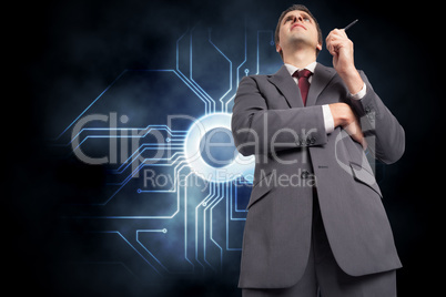 Composite image of thoughtful businessman holding pen