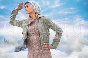 Composite image of concentrated young model in winter clothes wa