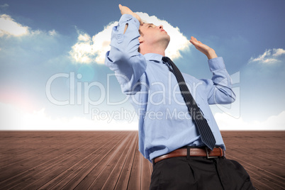 Composite image of businessman posing with arms raised