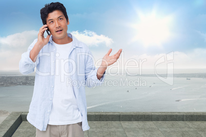 Composite image of clueless male on his cellphone