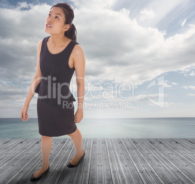 Composite image of asian businesswoman walking