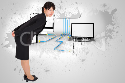 Composite image of serious businesswoman bending