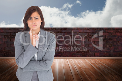 Composite image of worried businesswoman