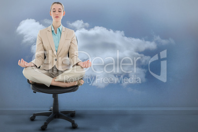 Composite image of peaceful chic businesswoman sitting in lotus