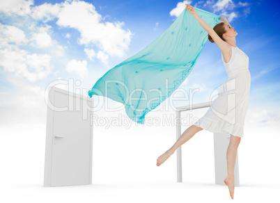 Composite image of young beautiful female dancer with blue scarf