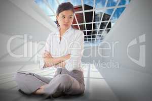 Composite image of annoyed businesswoman sitting with arms cross
