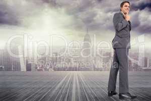 Composite image of thinking businessman with hand on chin