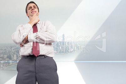 Composite image of thoughtful businessman with hand on chin