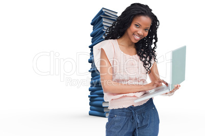 Composite image of a young woman holding a laptop is smiling at