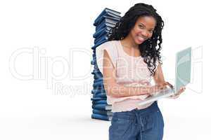 Composite image of a young woman holding a laptop is smiling at