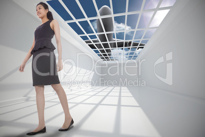 Composite image of asian businesswoman walking