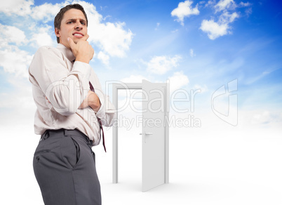 Composite image of thoughtful businessman with hand on chin