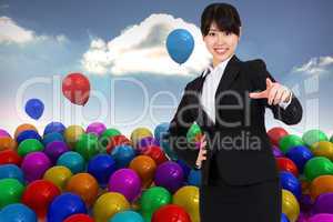 Composite image of smiling businesswoman pointing