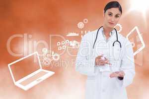 Composite image of female doctor pointing at pill in her hand