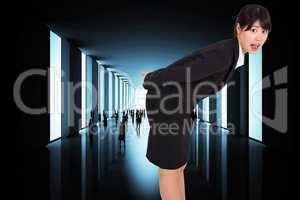 Composite image of surprised businesswoman bending