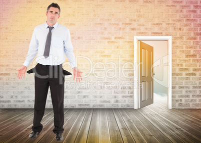 Composite image of businessman with empty pockets