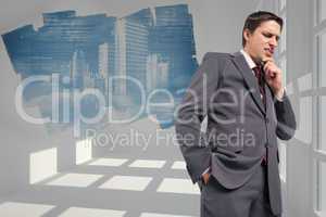 Composite image of thoughtful businessman with hand on chin