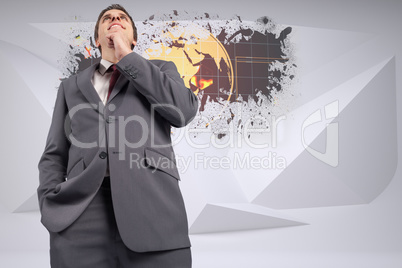 Composite image of thoughtful businessman with hand on chin