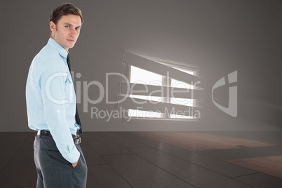 Composite image of serious businessman standing with hands in po