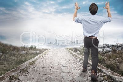 Composite image of businessman posing with arms up