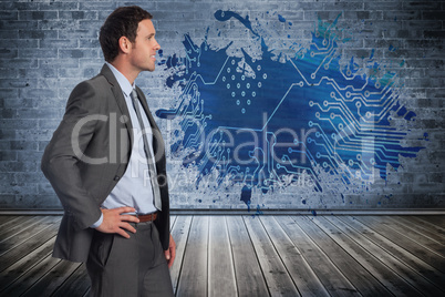 Composite image of smiling businessman with hand on hip